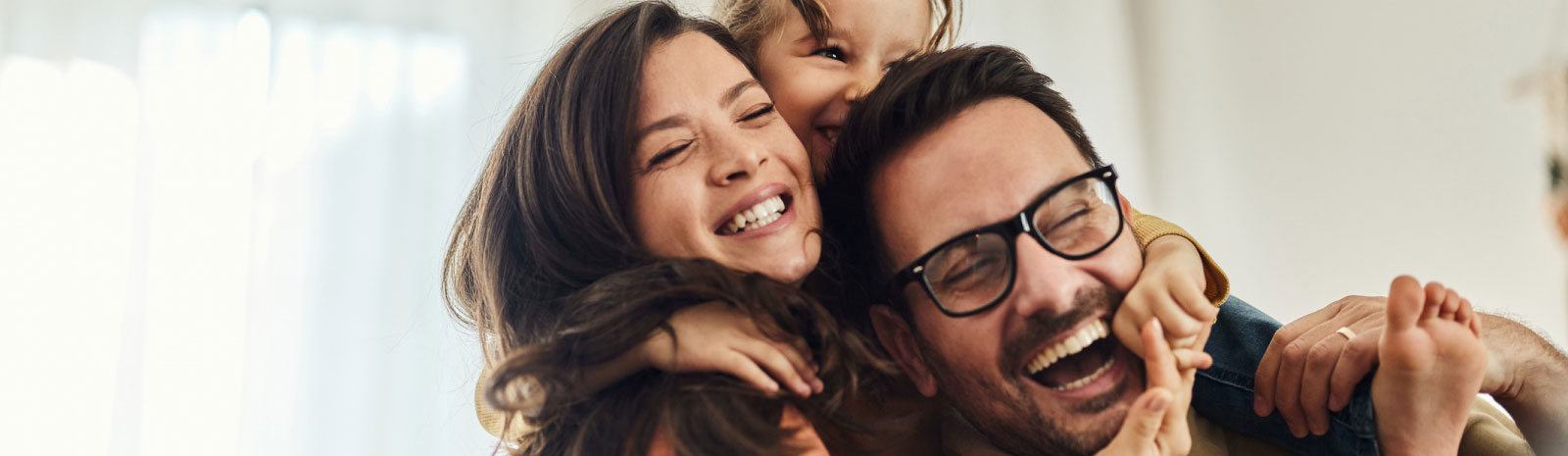 young family smiling and embracing 