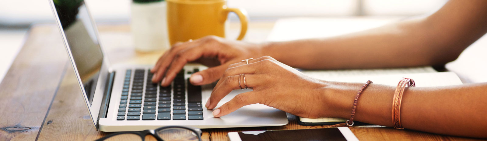 close-up of hands using a laptop