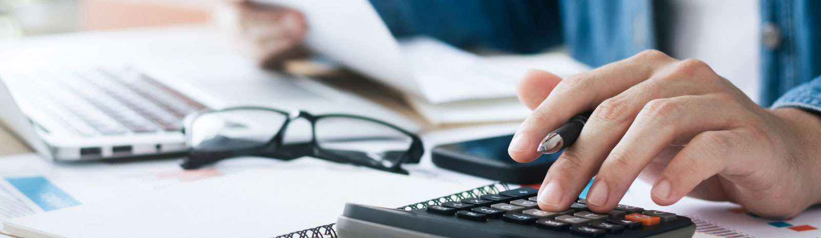 close-up of hands using a calculator