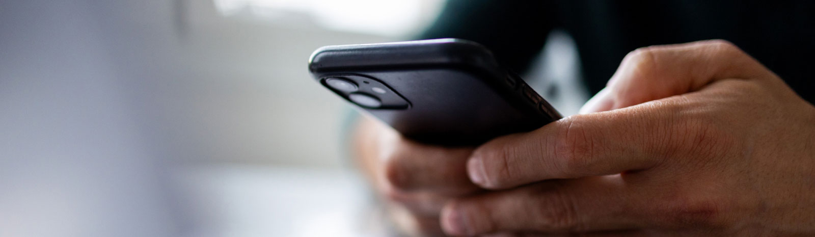 close-up of hands holding a smartphone